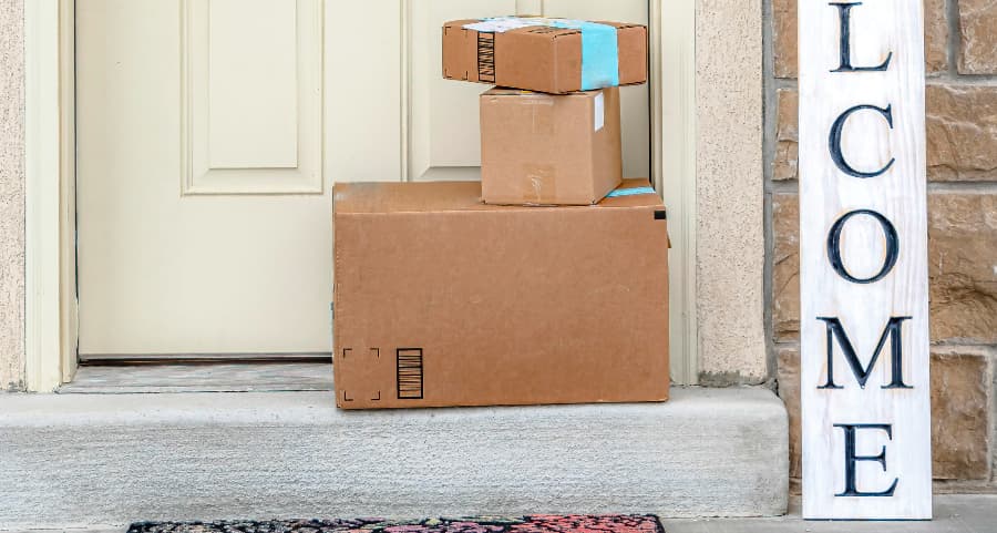 Deliveries on the front porch of a house with a welcome sign in Lansing